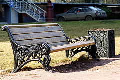 A park bench with a universal litter bin